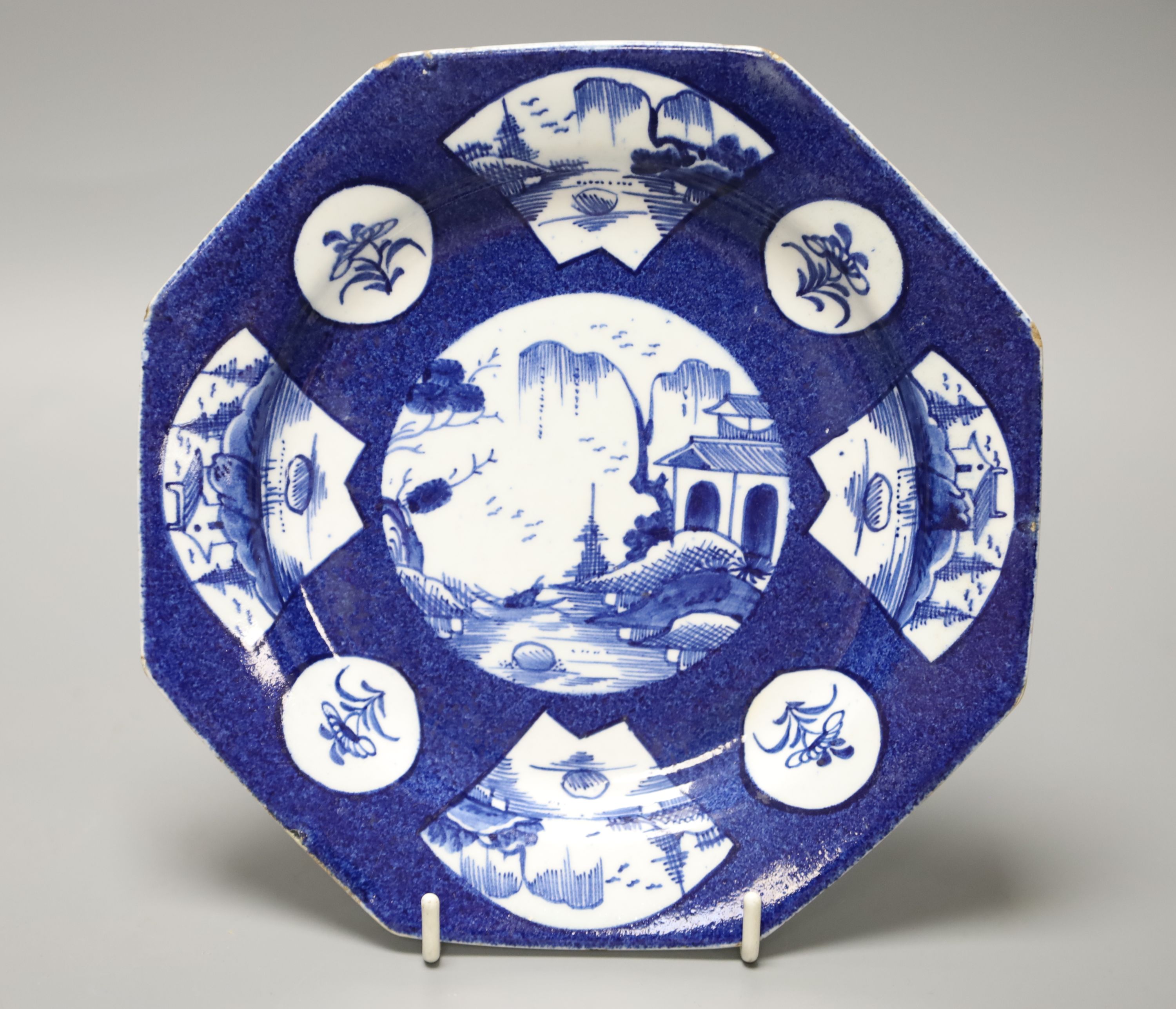 An 18th century Bow octagonal plate painted with landscapes or flowers in circular or fan-shaped panels on a powder blue ground, 19cm